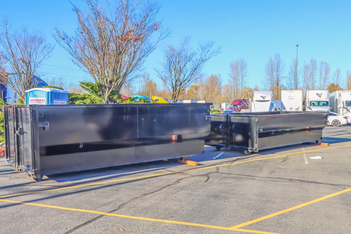 Professional dumpster rental service with roll-off container on residential driveway in Ferry Pass